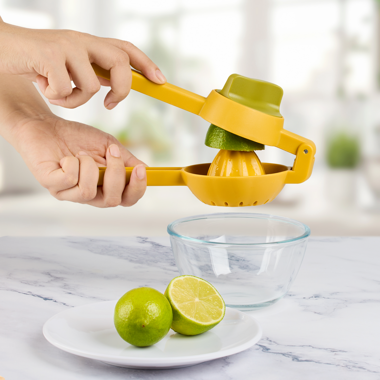 a hand squeezing a lime juicer