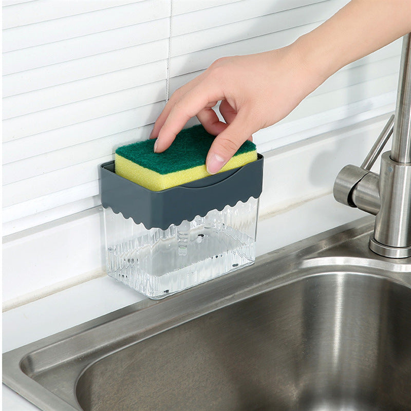 a hand holding a sponge over a sink