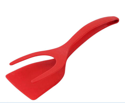 a red plastic scoop with a long handle