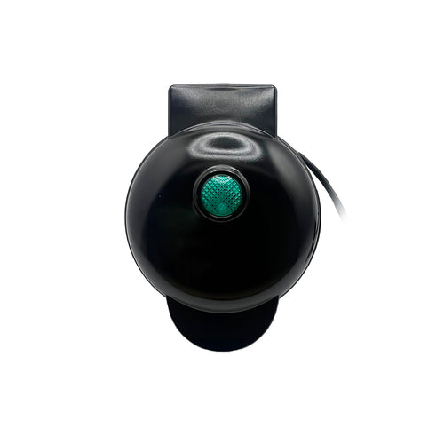 a black round object with a green light