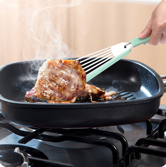 a person cooking meat on a pan