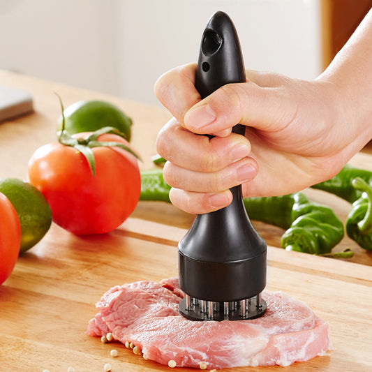 a hand holding a meat grinder