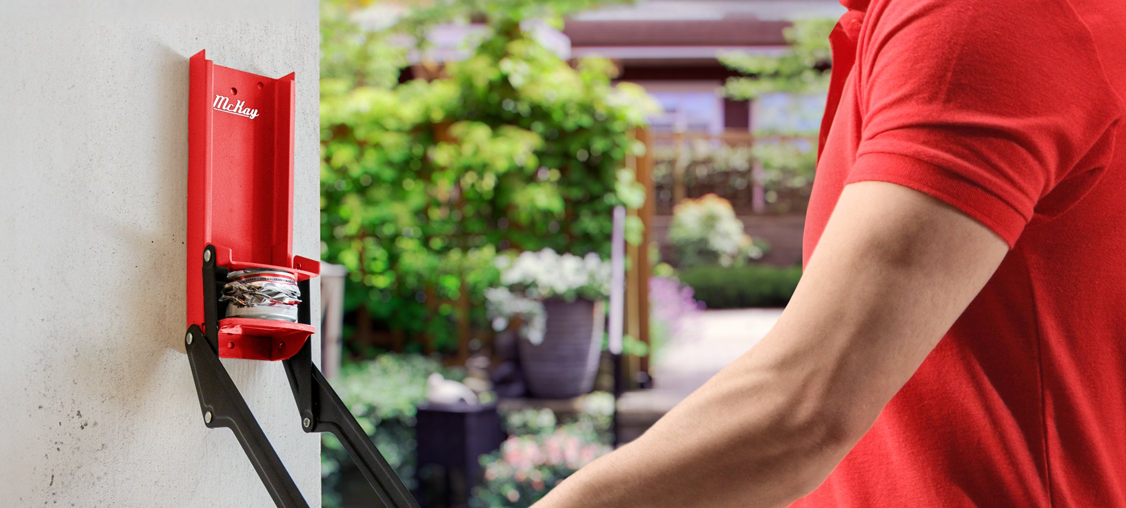 man pulling on red can crusher handle crushing a soda can