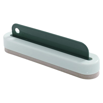 a white and grey object with a green handle
